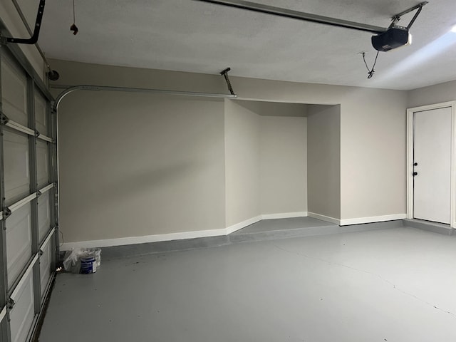 garage featuring baseboards and a garage door opener