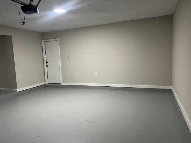garage with baseboards and a garage door opener