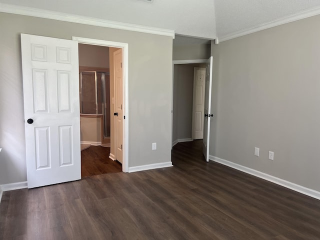 unfurnished bedroom featuring crown molding, baseboards, and dark wood finished floors