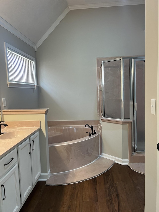 full bathroom with a shower stall, wood finished floors, vaulted ceiling, ornamental molding, and a bath