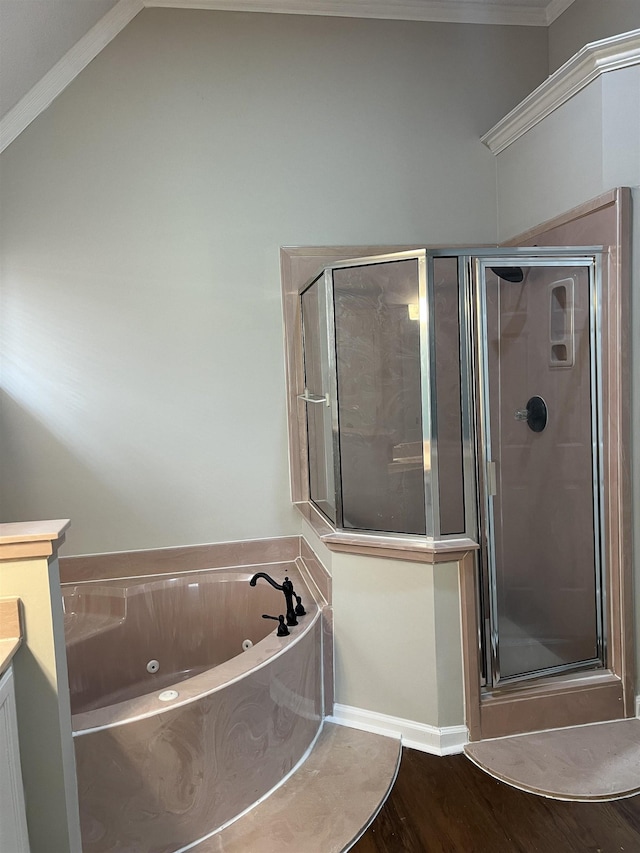 full bath featuring a jetted tub, a stall shower, wood finished floors, vanity, and ornamental molding