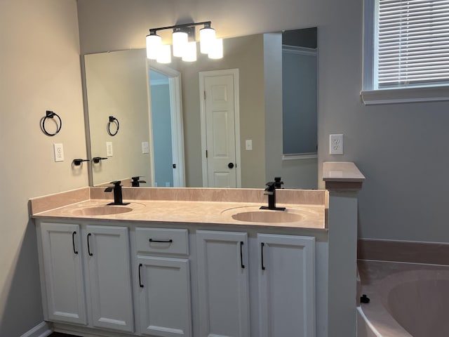 bathroom featuring double vanity, a sink, and a garden tub