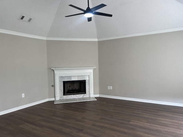 unfurnished living room featuring a ceiling fan, visible vents, a high end fireplace, dark wood-style floors, and lofted ceiling