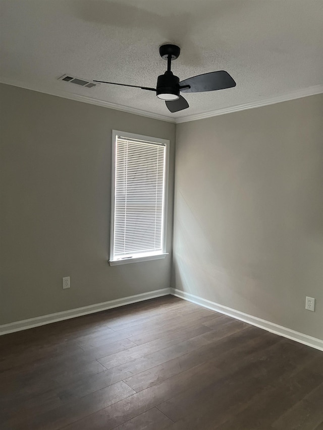 spare room with visible vents, crown molding, ceiling fan, dark wood-type flooring, and a textured ceiling