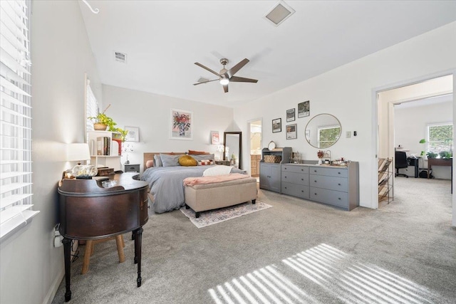 carpeted bedroom with visible vents and a ceiling fan