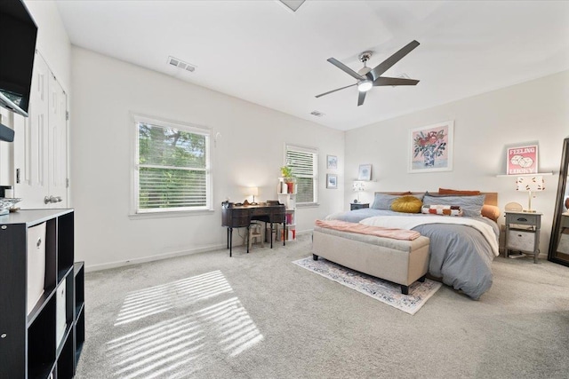 bedroom featuring visible vents, a ceiling fan, baseboards, and carpet floors