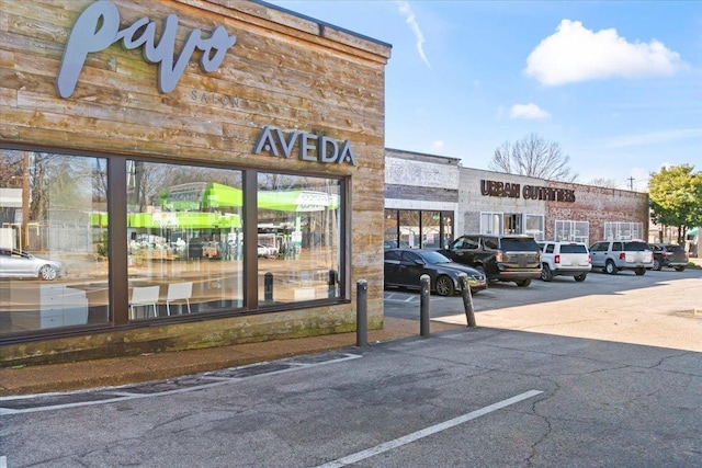 view of building exterior featuring uncovered parking