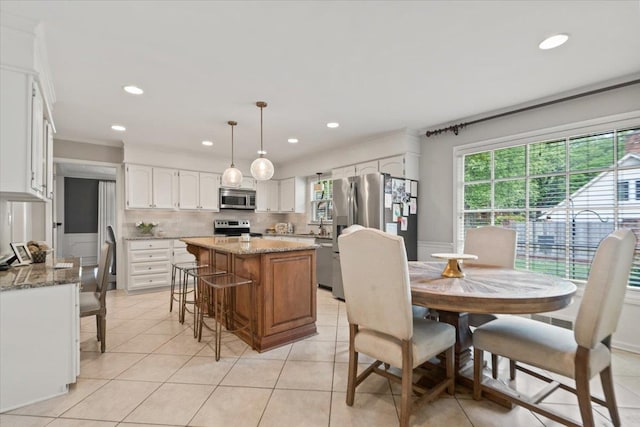 dining area featuring light tile patterned flooring, recessed lighting, and a healthy amount of sunlight