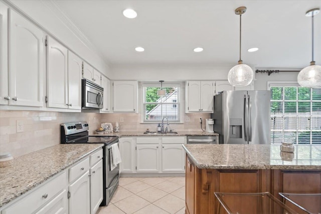 kitchen with a sink, stainless steel appliances, white cabinetry, and light tile patterned flooring
