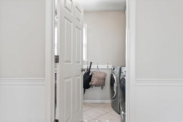 washroom featuring laundry area, independent washer and dryer, and light tile patterned floors