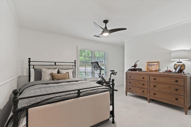 bedroom featuring ornamental molding, light carpet, ceiling fan, and visible vents