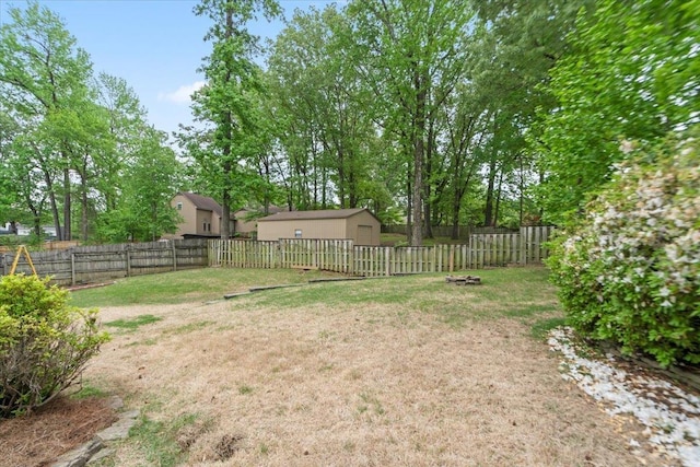 view of yard featuring a fenced backyard and an outdoor structure