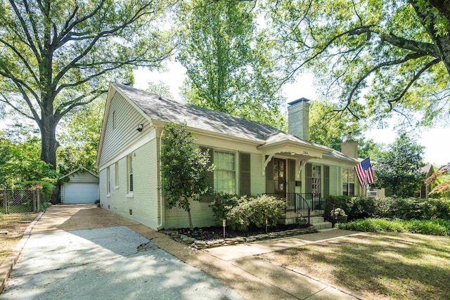 246 Palisade St, Memphis, TN 38111 - view of front facade with brick siding, a detached garage, a chimney, concrete driveway, and an outdoor structure