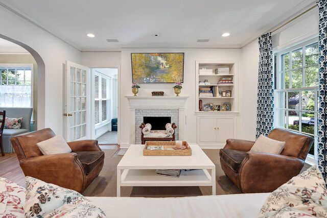 246 Palisade St, Memphis, TN 38111 - living area with crown molding, arched walkways, built in shelves, and a fireplace