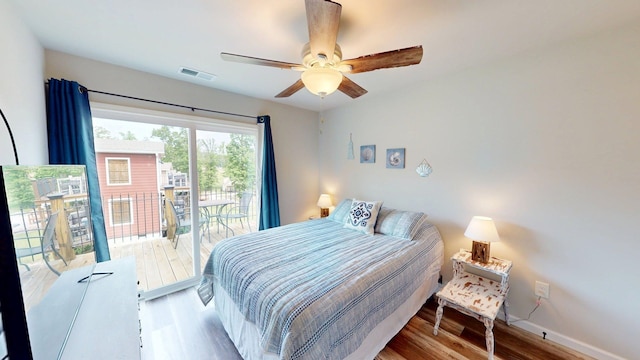 bedroom with visible vents, ceiling fan, wood finished floors, and access to exterior