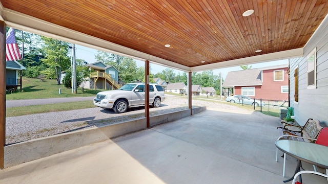 view of patio featuring a residential view and a carport