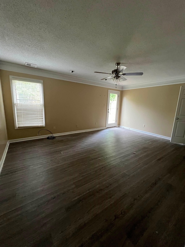 spare room featuring crown molding, baseboards, a textured ceiling, and dark wood-type flooring