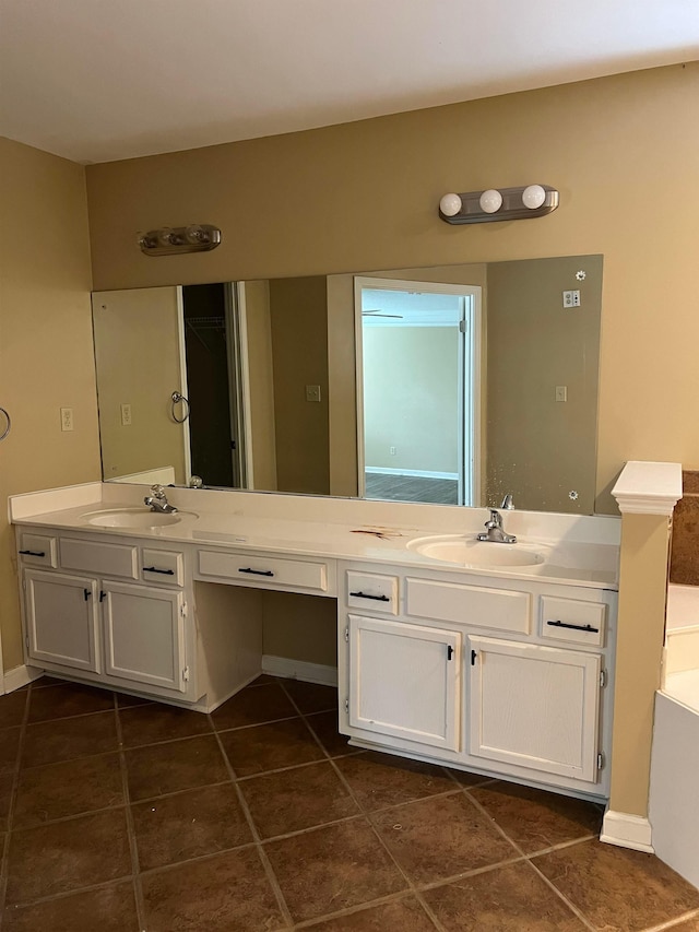 full bath featuring double vanity, tile patterned floors, and a sink