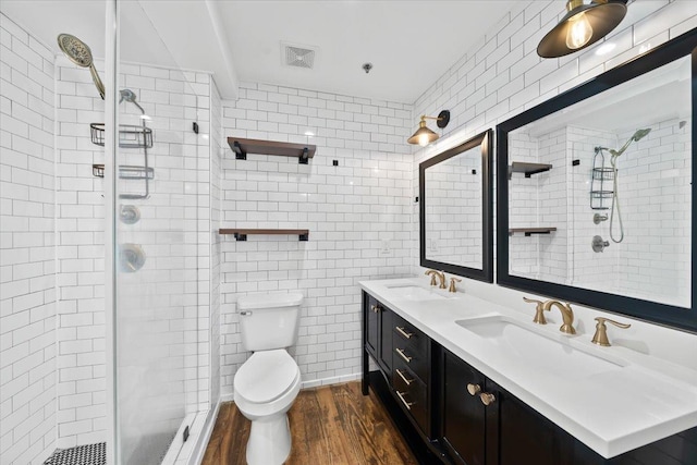 415 S Front St Unit 110, Memphis, TN 38103 - full bathroom with a stall shower, visible vents, a sink, and wood finished floors