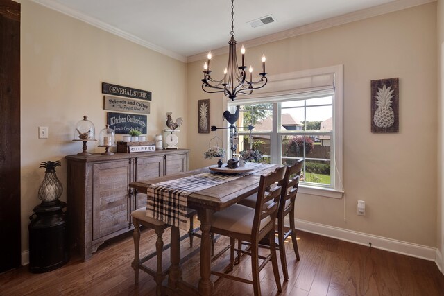 dining area featuring crown molding, dark wood-style flooring, an inviting chandelier, baseboards, and visible vents