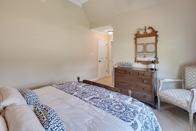 carpeted bedroom with baseboards, ornamental molding, and lofted ceiling