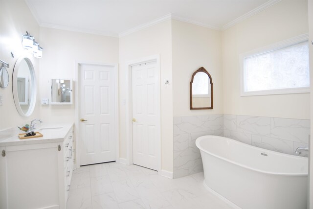 full bathroom with crown molding, a freestanding tub, vanity, and marble finish floor