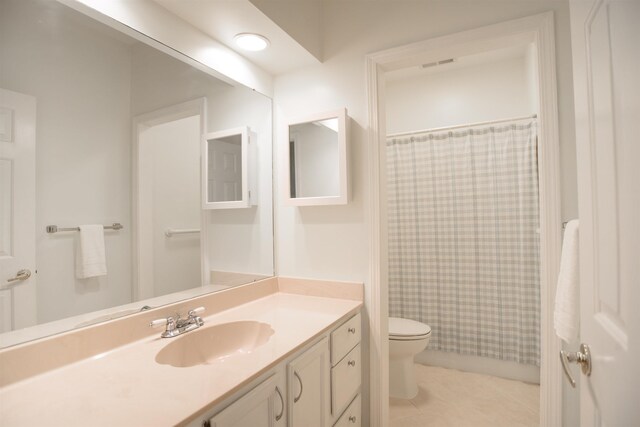 full bath featuring toilet, tile patterned floors, a shower with curtain, and vanity