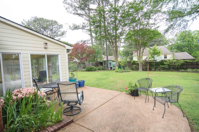 view of patio featuring an outdoor structure, a storage shed, and a fenced backyard