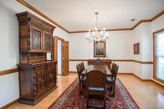 dining space featuring an inviting chandelier, plenty of natural light, and light wood-style flooring