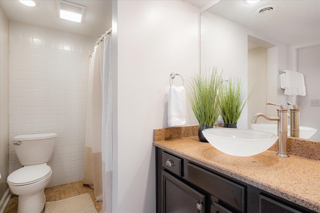 full bathroom with vanity, tile patterned floors, and toilet