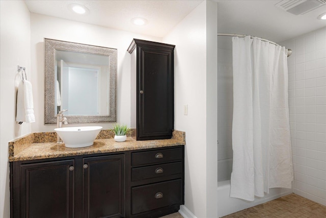 full bath with visible vents, shower / bath combination with curtain, and vanity