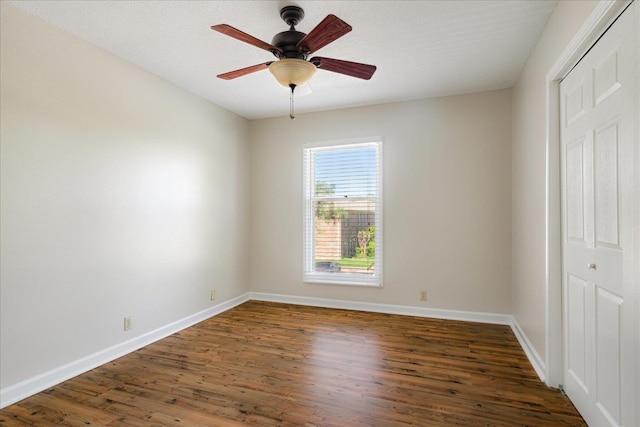 interior space with a ceiling fan, baseboards, and wood finished floors