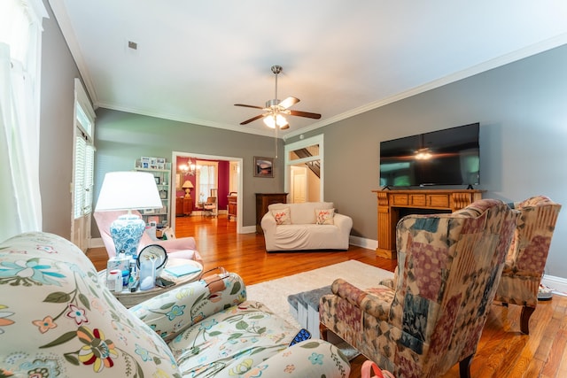 171 White St, Savannah, TN 38372 - living room featuring crown molding, a ceiling fan, wood finished floors, and a fireplace