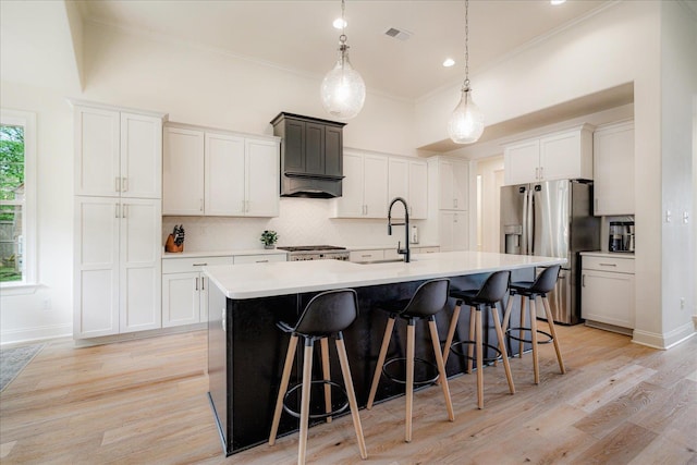 5082 Moudry Run Cv, Lakeland, TN 38002 - kitchen featuring visible vents, light countertops, stainless steel fridge with ice dispenser, a sink, and backsplash