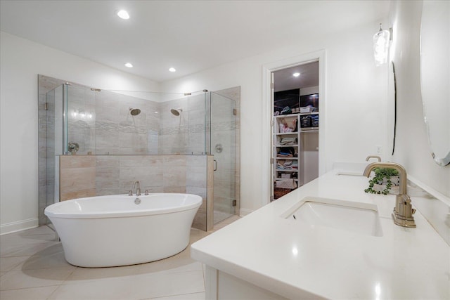 5082 Moudry Run Cv, Lakeland, TN 38002 - bathroom featuring a walk in closet, a freestanding bath, a stall shower, a sink, and recessed lighting
