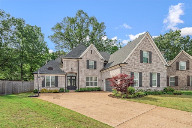 5082 Moudry Run Cv, Lakeland, TN 38002 - view of front facade with brick siding, fence, french doors, and driveway