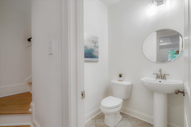 5082 Moudry Run Cv, Lakeland, TN 38002 - half bathroom with baseboards, a sink, tile patterned floors, and toilet