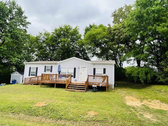 325 Geans Ln, Savannah, TN 38372 - rear view of property with a storage unit, an outbuilding, a yard, and a deck