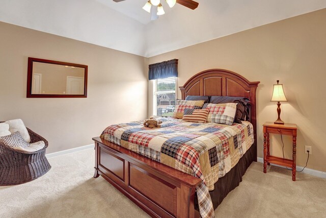bedroom featuring baseboards, a ceiling fan, vaulted ceiling, and light carpet