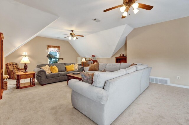 living room with ceiling fan, light carpet, vaulted ceiling, and visible vents