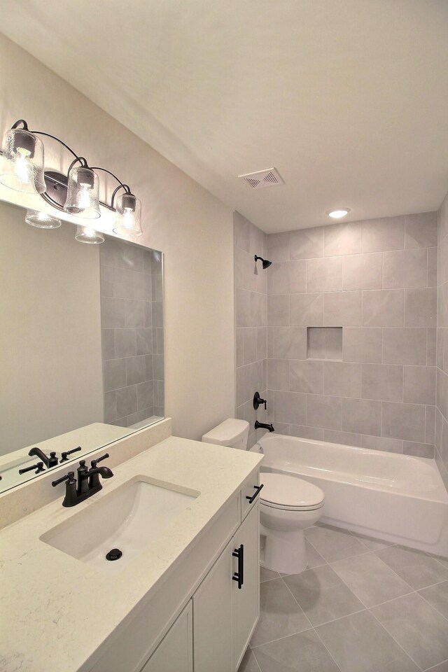 235 Freedom Ln, Rossville, TN 38066 - bathroom with tile patterned flooring, vanity, toilet, bathing tub / shower combination, and visible vents