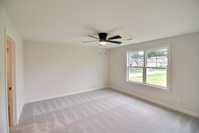 235 Freedom Ln, Rossville, TN 38066 - unfurnished room with a ceiling fan, baseboards, visible vents, and light carpet
