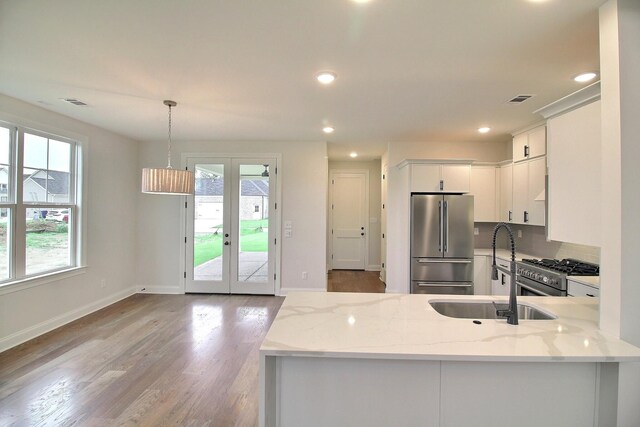 235 Freedom Ln, Rossville, TN 38066 - kitchen featuring french doors, a sink, light wood finished floors, premium appliances, and white cabinetry