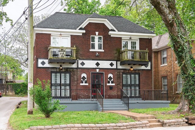 view of front of house featuring a porch, brick siding, and a balcony