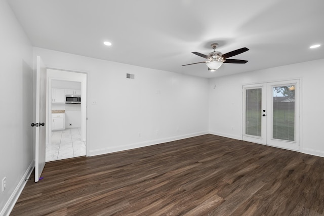 empty room featuring visible vents, dark wood-style flooring, ceiling fan, recessed lighting, and french doors