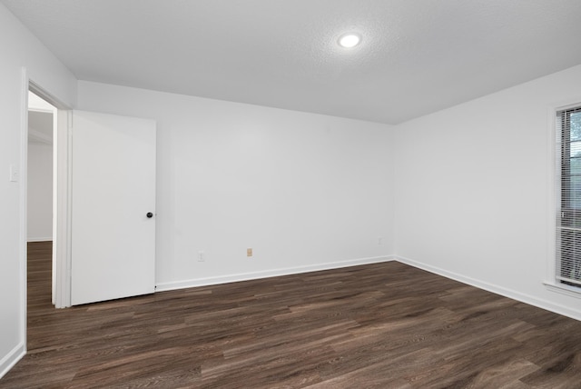 unfurnished bedroom with recessed lighting, baseboards, a textured ceiling, and dark wood-type flooring