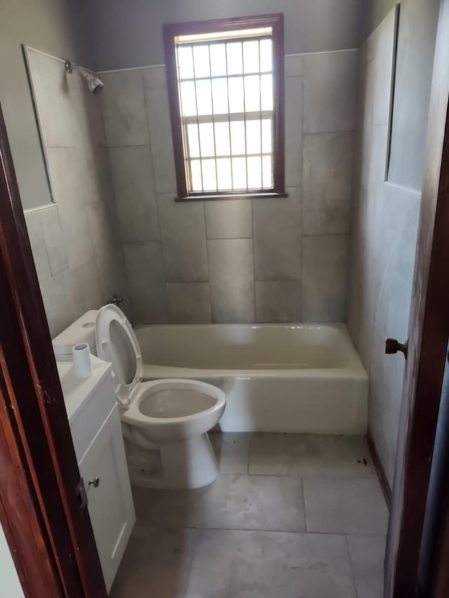 bathroom with toilet,  shower combination, and vanity