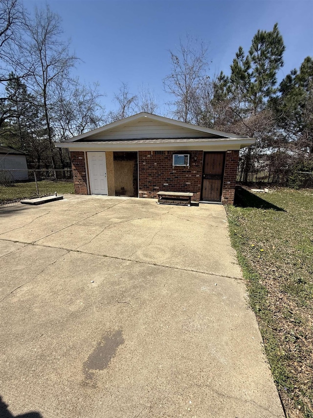 exterior space with brick siding and fence