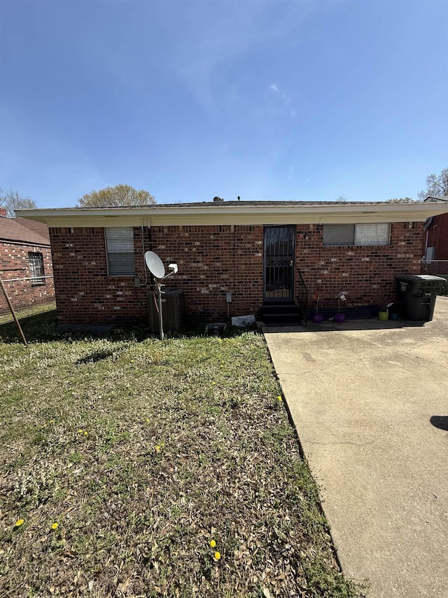 exterior space with brick siding and fence