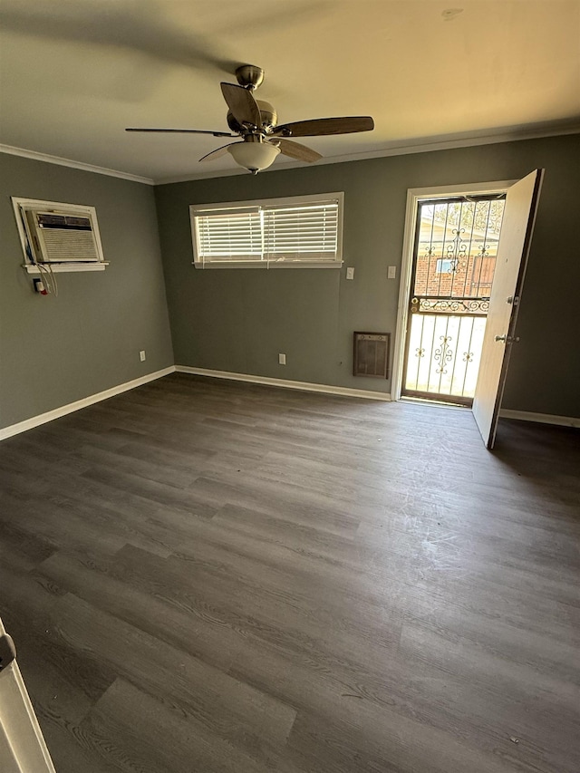 unfurnished room featuring baseboards, ornamental molding, ceiling fan, and dark wood-style floors